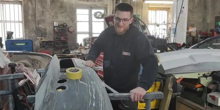 Expert technician performing car body repair